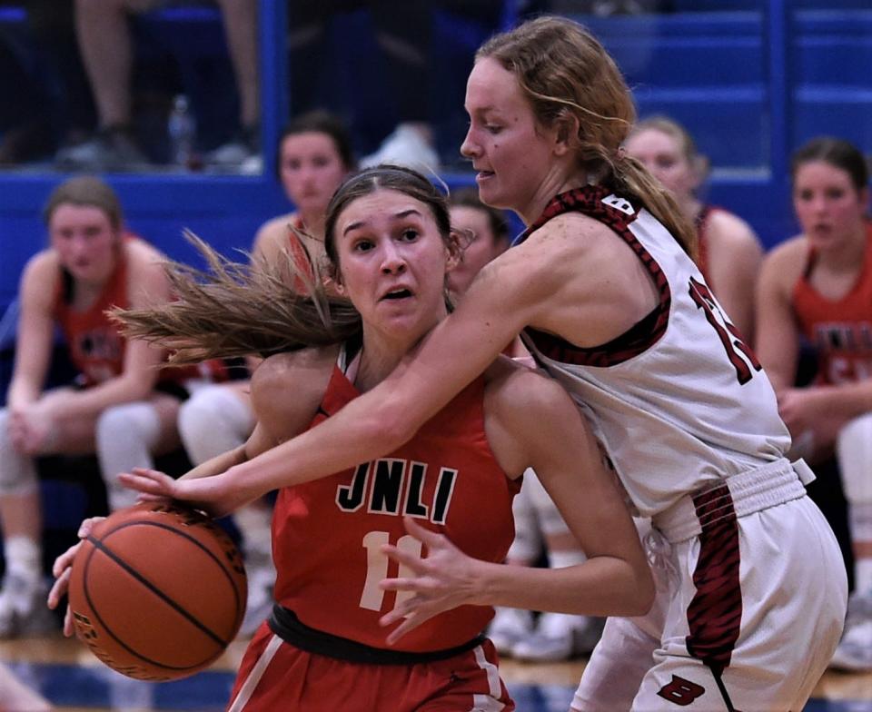 Jim Ned's Gracee Cooley, left, tries to get past Ballinger's Skyla Hostetter in the second half. Jim Ned won the Region I-3A quarterfinal 53-18 on Monday, Feb. 20, 2023, in Winters.