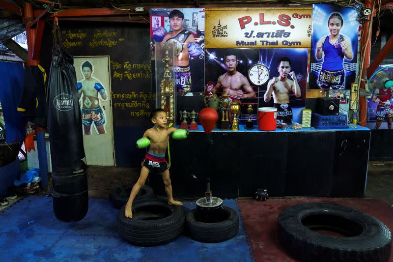 The Wider Image: Punching out of poverty: Despite risks, nine-year-old Thai fighter eager to return to ring