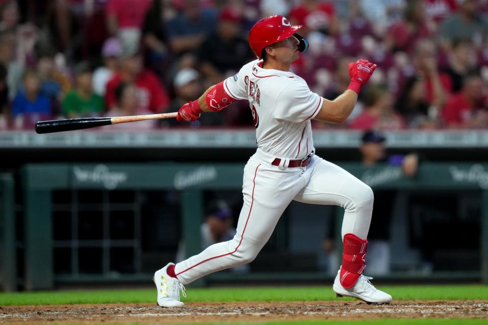 Cincinnati Reds third baseman Spencer Steer (12) hits a solo home run during the fifth inning of a baseball game against the Colorado Rockies, Friday, Sept. 2, 2022, at Great American Ball Park in Cincinnati. The hit marked the first of Steer’s major-league career. 