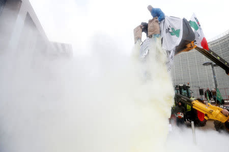 Milk producers spray powdered milk to protest against dairy market overcapacity outside a meeting of European Union agriculture ministers in Brussels, Belgium, January 23, 2017. REUTERS/Francois Lenoir