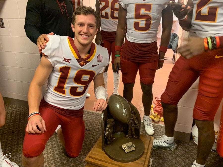 Iowa State senior Beau Coberley posed alongside the Cy-Hawk trophy after the Cyclones beat Iowa in September. He struck much the same pose, but as a little kid, after Iowa State won the 2007 Cy-Hawk trophy. Saturday, he'll be honored on Senior Day before the 6 p.m. game against Texas Tech at Jack Trice Stadium.