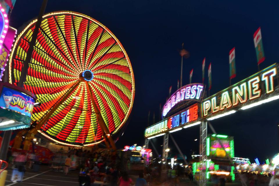 Colorful rides light up the Midway at the 100th Delaware State Fair in July 2019. This year's fair begins Thursday and masks must be worn to gain entry.