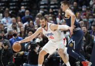 Los Angeles Clippers center Ivica Zubac, left, clears out Denver Nuggets center Nikola Jokic on the way to the rim in the first half of an NBA basketball game Wednesday, Jan. 19, 2022, in Denver. (AP Photo/David Zalubowski)