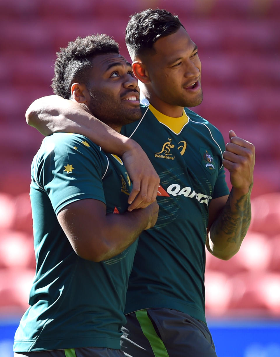 Samu Kerevi (pictured left) is embraced by Israel Folau (pictured right).