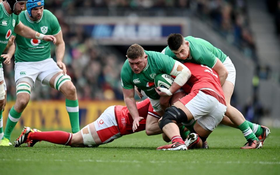 Tadhg Furlong of Ireland is tackled by Aaron Wainwright and Dafydd Jenkins of Wales