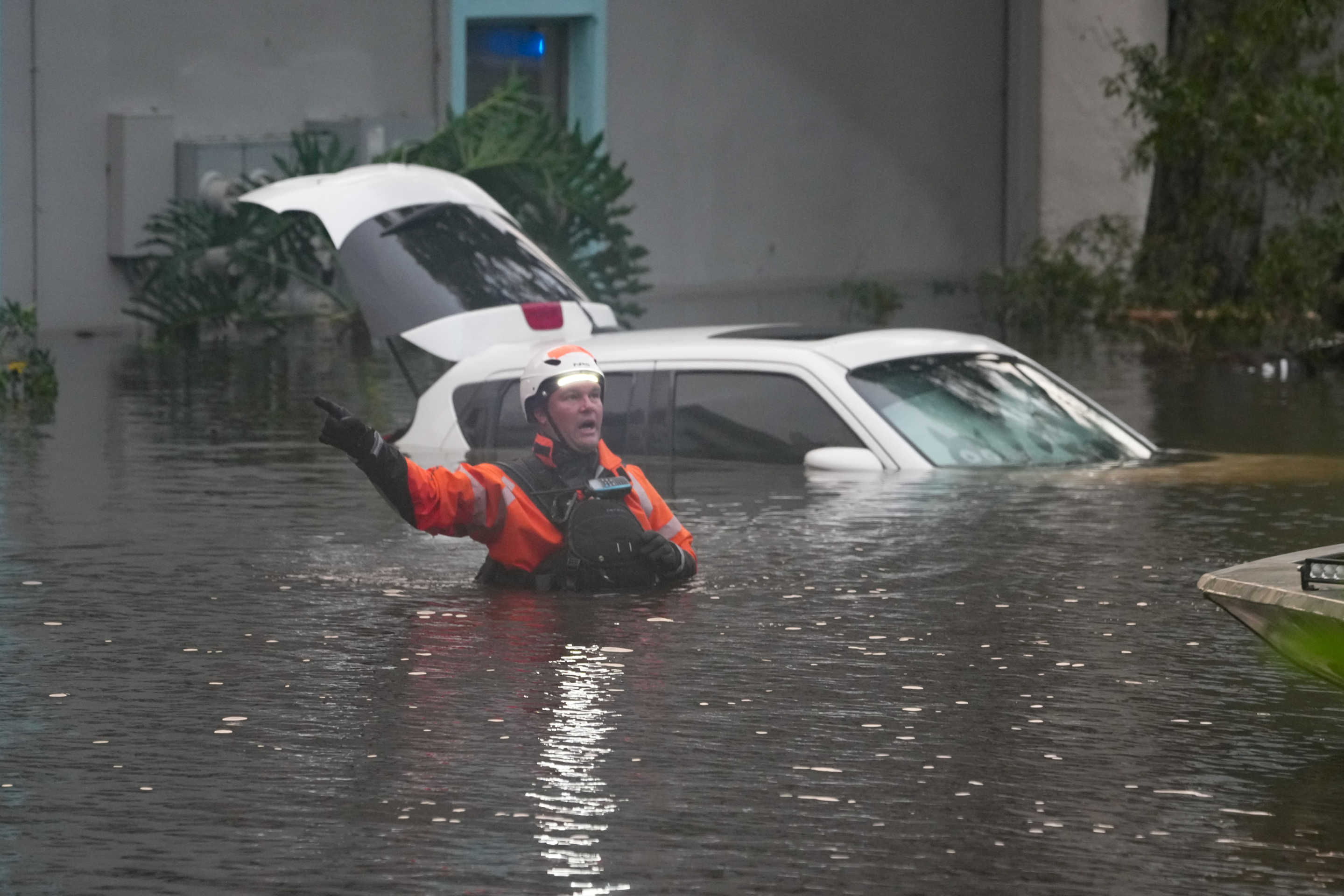 First responders in the water outside an apartment complex inundated by a flooded creek due to Hurricane Milton on October 10, 2024 in Clearwater, Florida. (Bryan R. Smith/AFP via Getty Images)