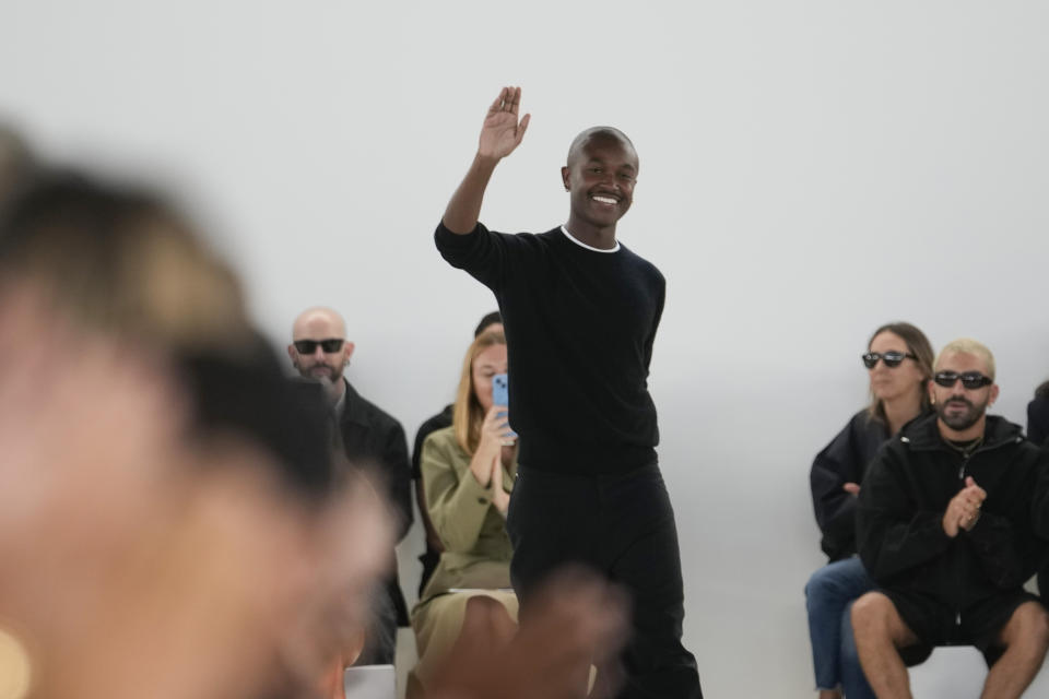 Creative director Maximilian Davies waves to spectators at the end of the Ferragamo women's Spring Summer 2024 fashion show, presented in Milan, Italy, Saturday, Sept. 23, 2023. (AP Photo/Luca Bruno)