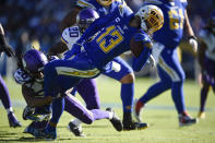 Los Angeles Chargers wide receiver Keenan Allen is brought down by Minnesota Vikings cornerback Trae Waynes, left, during the first half of an NFL football game Sunday, Dec. 15, 2019, in Carson, Calif. (AP Photo/Kelvin Kuo)
