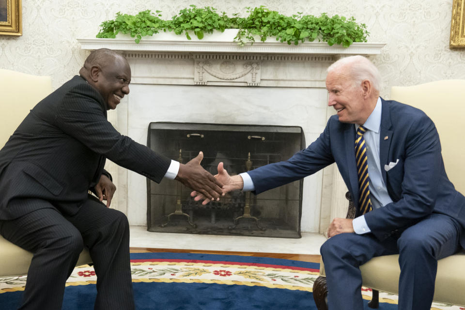 FILE - President Joe Biden shakes hands with South African President Cyril Ramaphosa in the Oval Office of the White House, Friday, Sept. 16, 2022, in Washington. A bipartisan group of U.S. lawmakers wants the Biden Administration to punish South Africa for what they call its support for Russia's illegal invasion of Ukraine by relocating this year's AGOA America-Africa trade meeting to another country. (AP Photo/Alex Brandon/File)