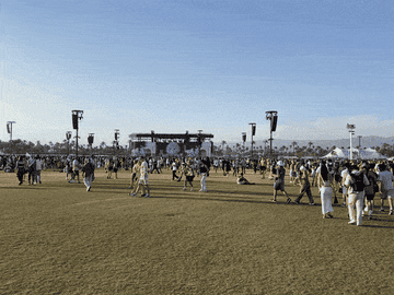 people walking and sitting at coachella