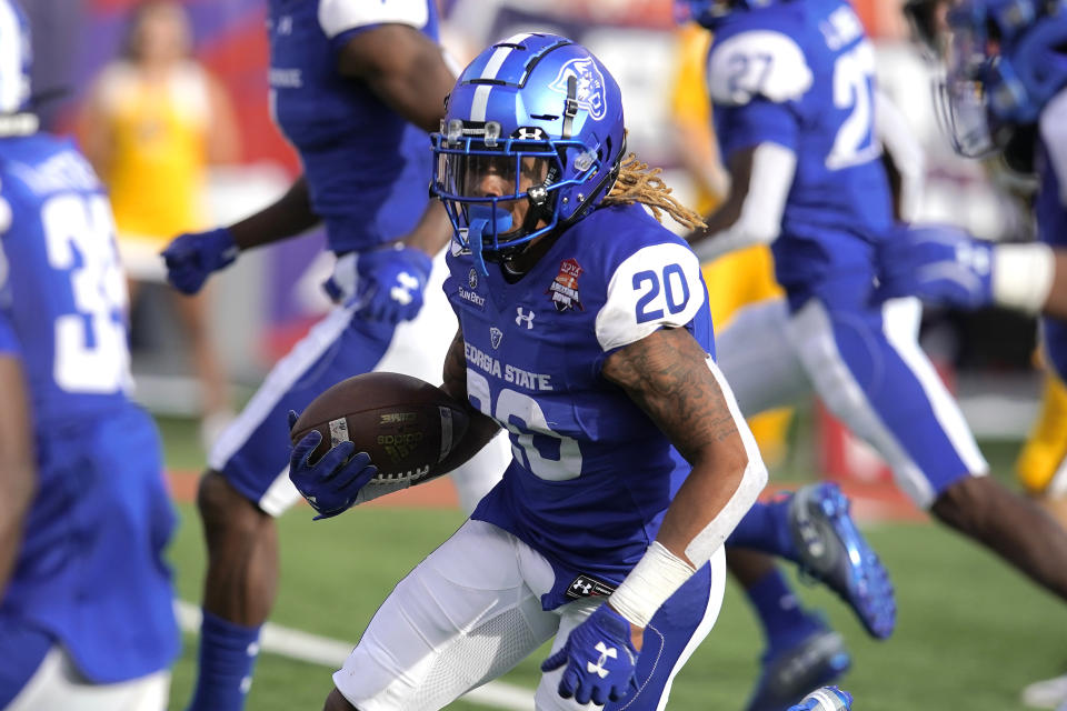 Georgia State cornerback Quavian White (20) runs with the ball after intercepting a pass in the first half of the Arizona Bowl NCAA college football game, Tuesday, Dec. 31, 2019, in Tucson, Ariz. (AP Photo/Rick Scuteri)