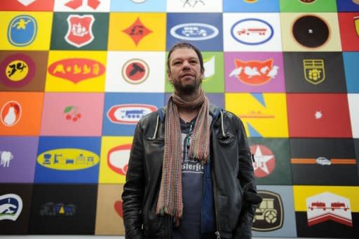 German artist Konstantin Voit poses for a picture in front of his installation "Die Malfabrik: Werbeblock" on display at the exibition "I love Aldi" at the Wilhelm Hack Museum in Ludwigshafen am Rhein, western Germany
