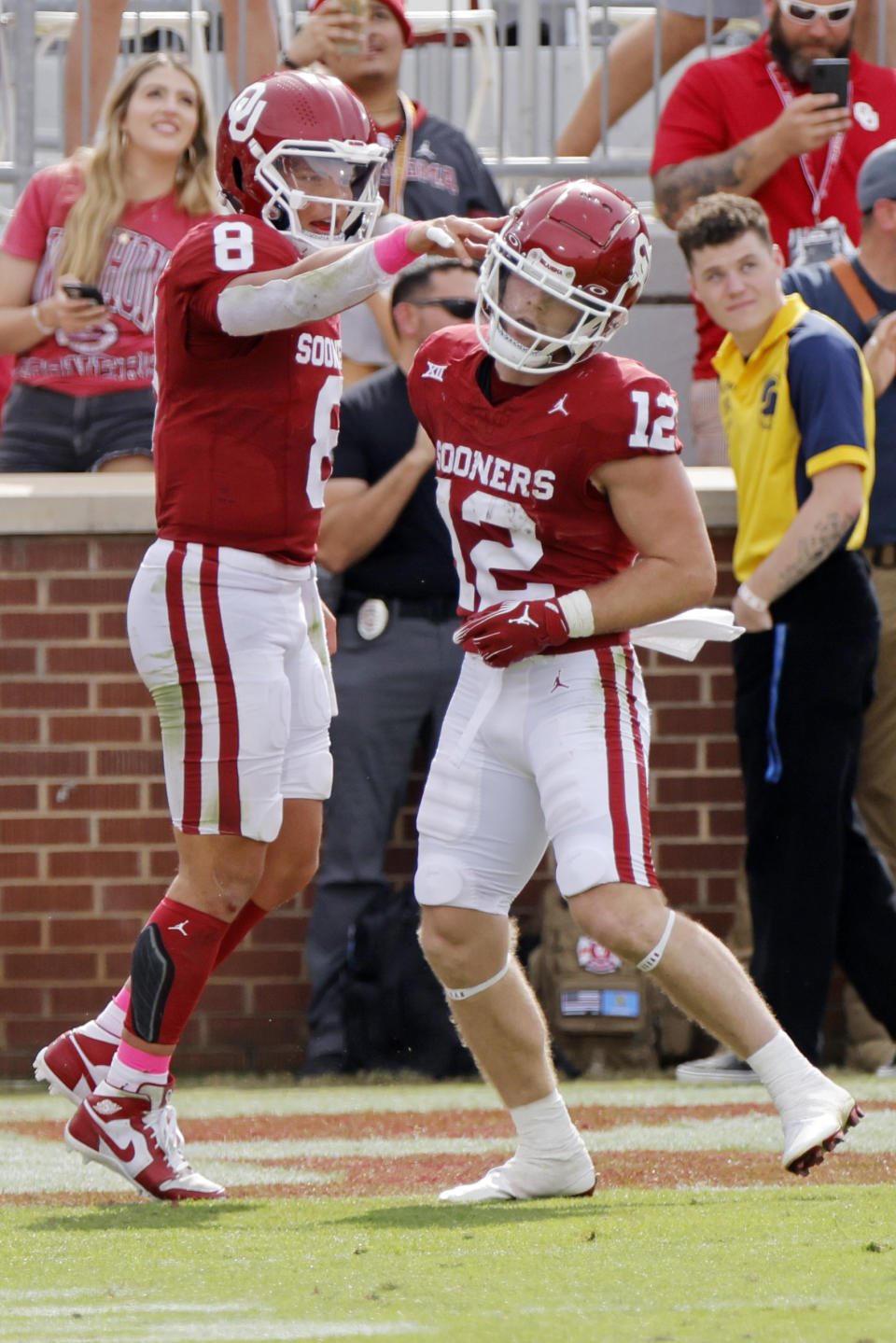 Oklahoma quarterback Dillon Gabriel (8) and wide receiver Drake Stoops (12) celebrate after Gabriel threw a touchdown pass to Stoops in the second half of an NCAA college football game against UCF, Saturday, Oct. 21, 2023, in Norman, Okla. (AP Photo/Nate Billings)
