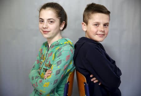 Twins Mirela (L) and Mujo Balcinovic pose for a portrait in a primary school in Buzim April 10, 2015. REUTERS/Dado Ruvic