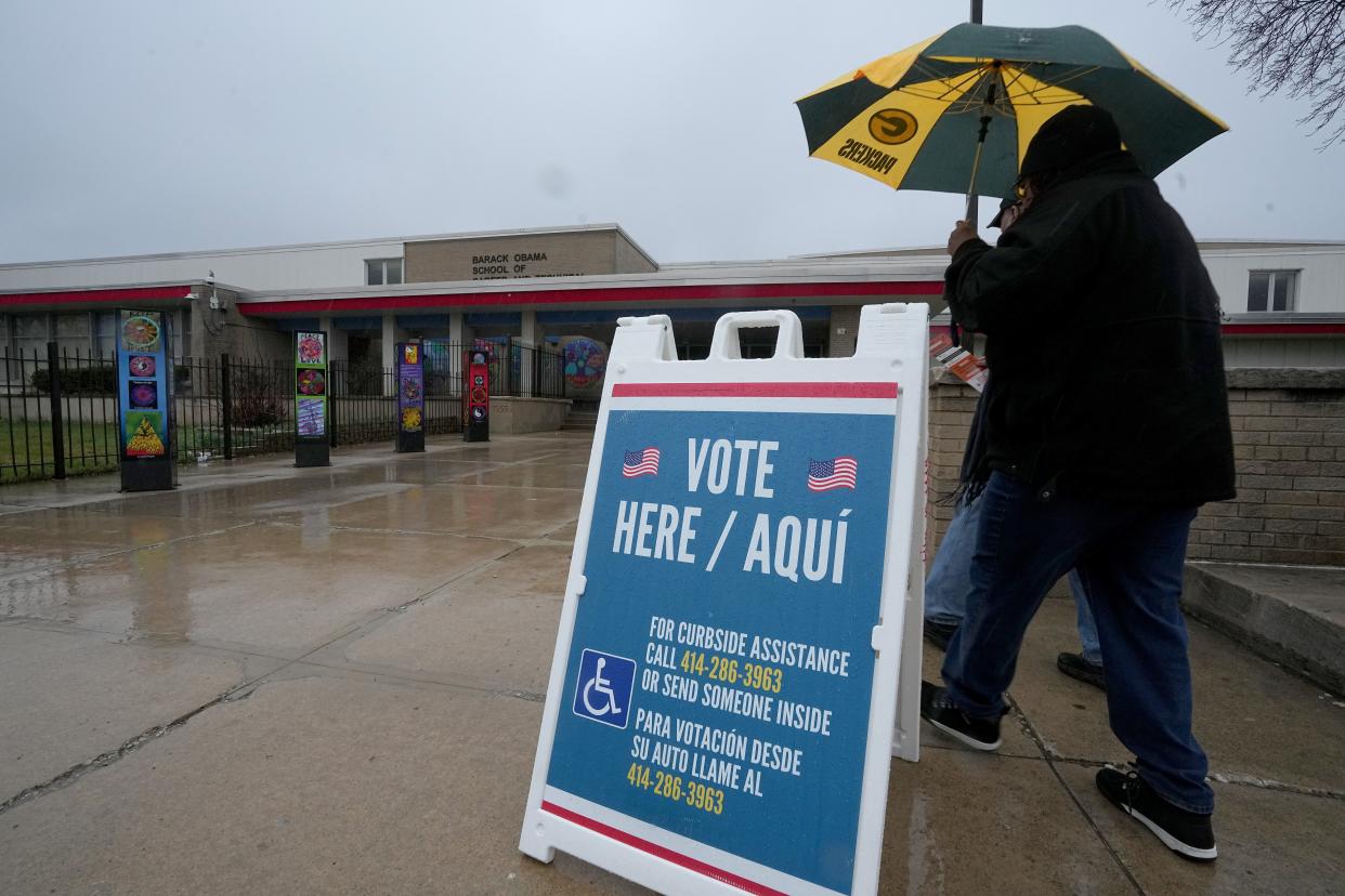 People brave the rain to vote in the spring and presidential preference election Tuesday, April 2, 2024 at the Barack Obama School of Career and Technical Education, 5075 N. Sherman Blvd. in Milwaukee, Wisconsin. In addition to local races, voters everywhere will weigh in on two statewide referendum questions that ask about private funding in election administration and the role of election officials.