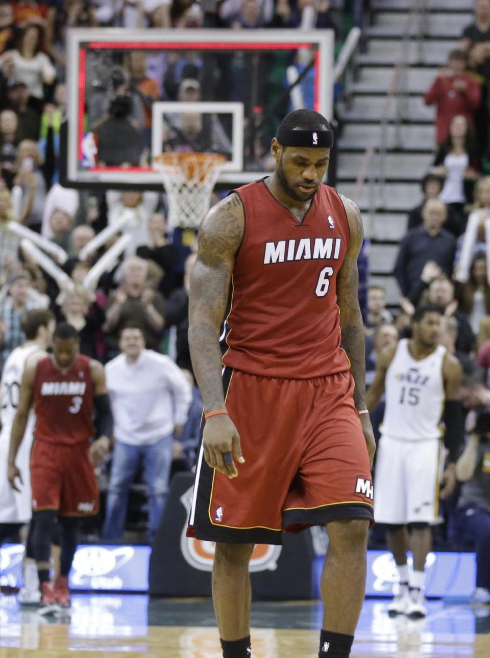 Miami Heat's LeBron James walks off the court at the end of an NBA basketball game against the Utah Jazz on Saturday, Feb. 8, 2014, in Salt Lake City. The Jazz won 94-89. (AP Photo/Rick Bowmer)