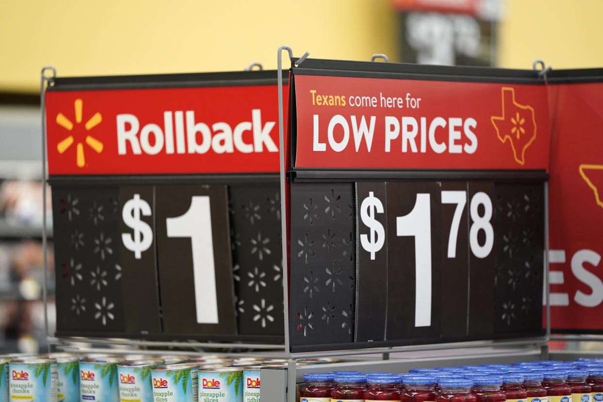 Signs promote sales at a Walmart Supercenter Friday, Nov. 9, 2018, in Houston. (AP Photo/David J. Phillip)