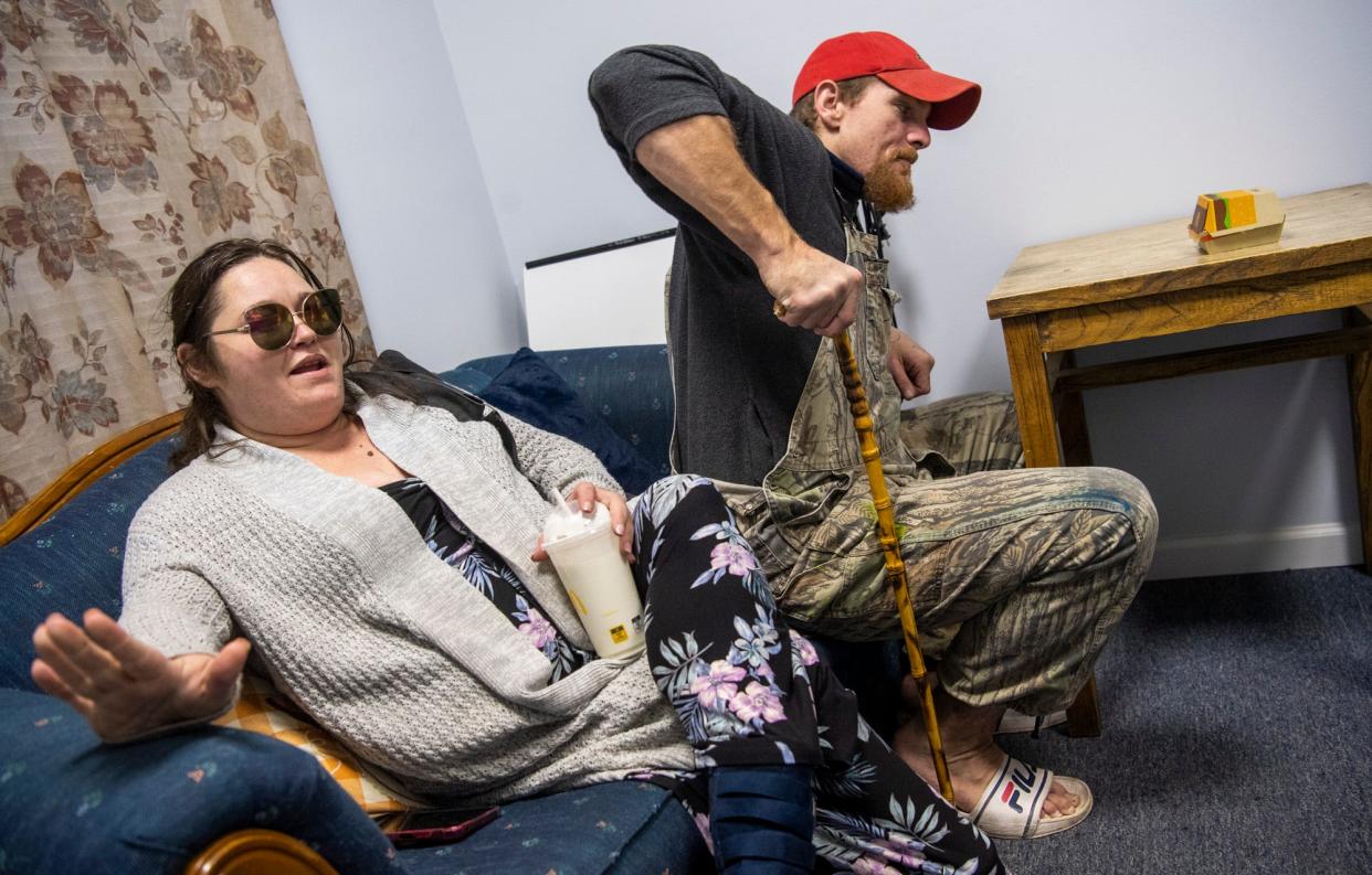 Alicia Reed sits next to her husband, Nathaniel Reed  as they meet  with Katie Norris, executive director for Hotels For Homeless, as they try to find housing for the night on Tuesday, Nov. 29, 2022.