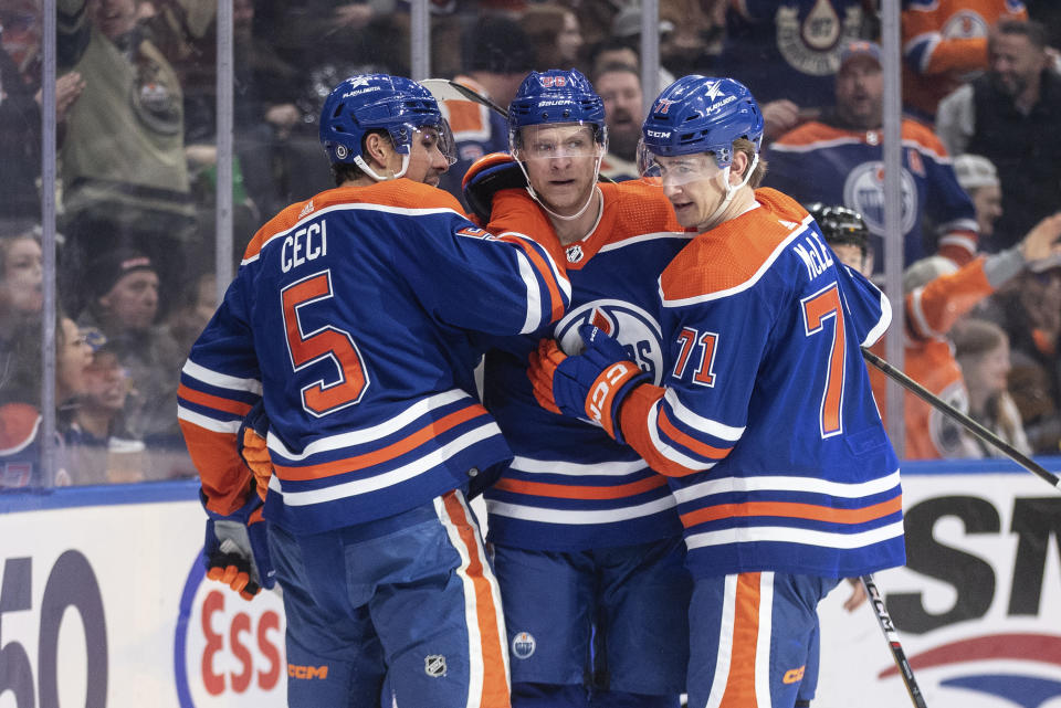 Edmonton Oilers' Cody Ceci (5), Corey Perry and Ryan McLeod celebrate a goal against the Pittsburg Penguins during the second period of an NHL hockey game in Edmonton, Alberta, on Sunday March 3, 2024. (Jason Franson/The Canadian Press via AP)