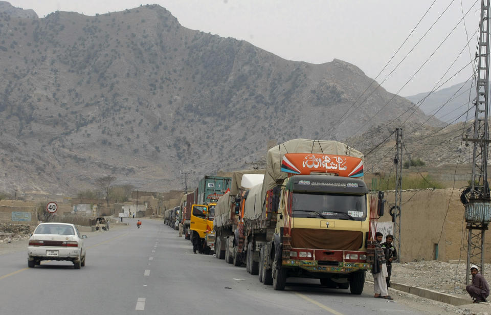 Truck drivers stand beside their trucks while they waiting for border opening at a highway leading to Torkhum, a border crossing between Pakistan Afghanistan, Monday, March, 20, 2017. Pakistan's prime minister ordered the reopening of the country's border with Afghanistan on Monday, ending a protracted closure that has cost businesses on both sides millions of dollars and deepened tensions between the two neighbors. (AP Photo/Matiullah Achakzai)