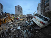 <p>Emergency teams search for people in a destroyed building in Adana, Turkey, Monday, Feb. 6, 2023. A powerful quake has knocked down multiple buildings in southeast Turkey and Syria and many casualties are feared. (DIA Images via AP)</p> 