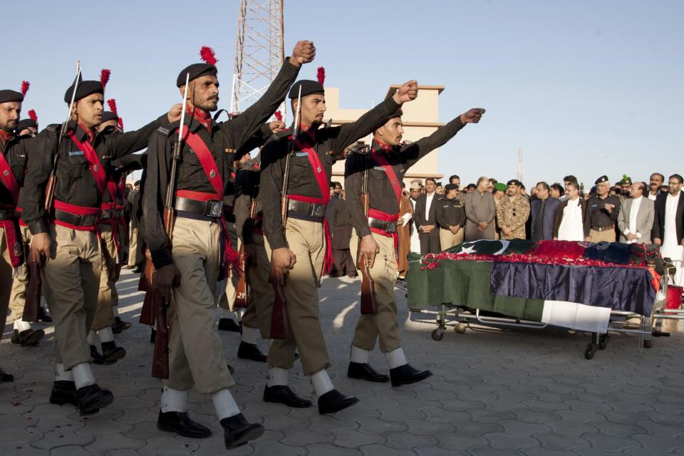 In this Friday, Jan. 10, 2014 photo, Pakistani policemen march near the body of police officer Chaudhry Aslam, who was killed in a bomb attack claimed by the Pakistani Taliban, during his funeral procession in Karachi, Pakistan. 44 police officers were killed in the line of duty during the first two months of the year in Karachi, marking a particularly violent beginning of the year for police. This spike came after the police were already reeling from the killings of 166 officers last year _ roughly one every other day and a four-fold increase from just five years earlier. (AP Photo/Shakil Adil)