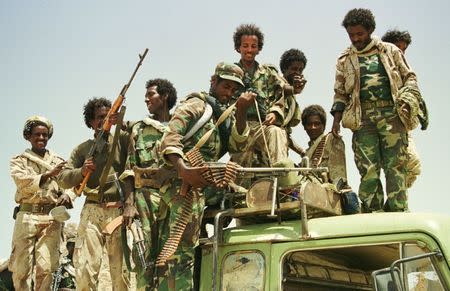 Jubilant Eritrean troops show off their weapons after recapturing the western Eritrean town of Tesseney from Ethiopian forces June 6, 2000. REUTERS/Stringer/File Photo