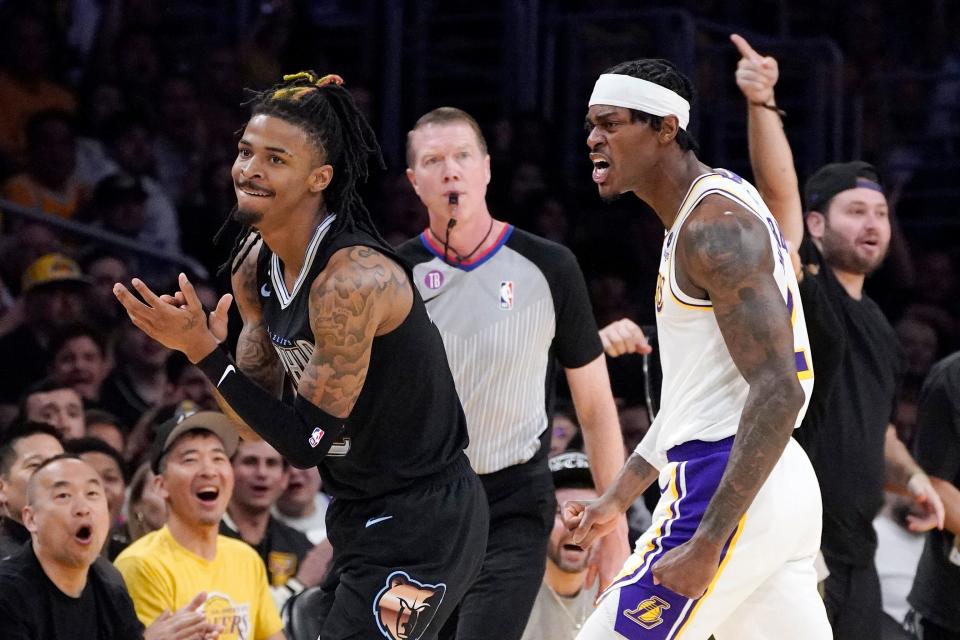 Memphis Grizzlies guard Ja Morant, left, and Los Angeles Lakers forward Jarred Vanderbilt, right, reacts after Morant lost the ball out of bounds during the first half in Game 3 of a first-round NBA basketball playoff series Saturday, April 22, 2023, in Los Angeles.