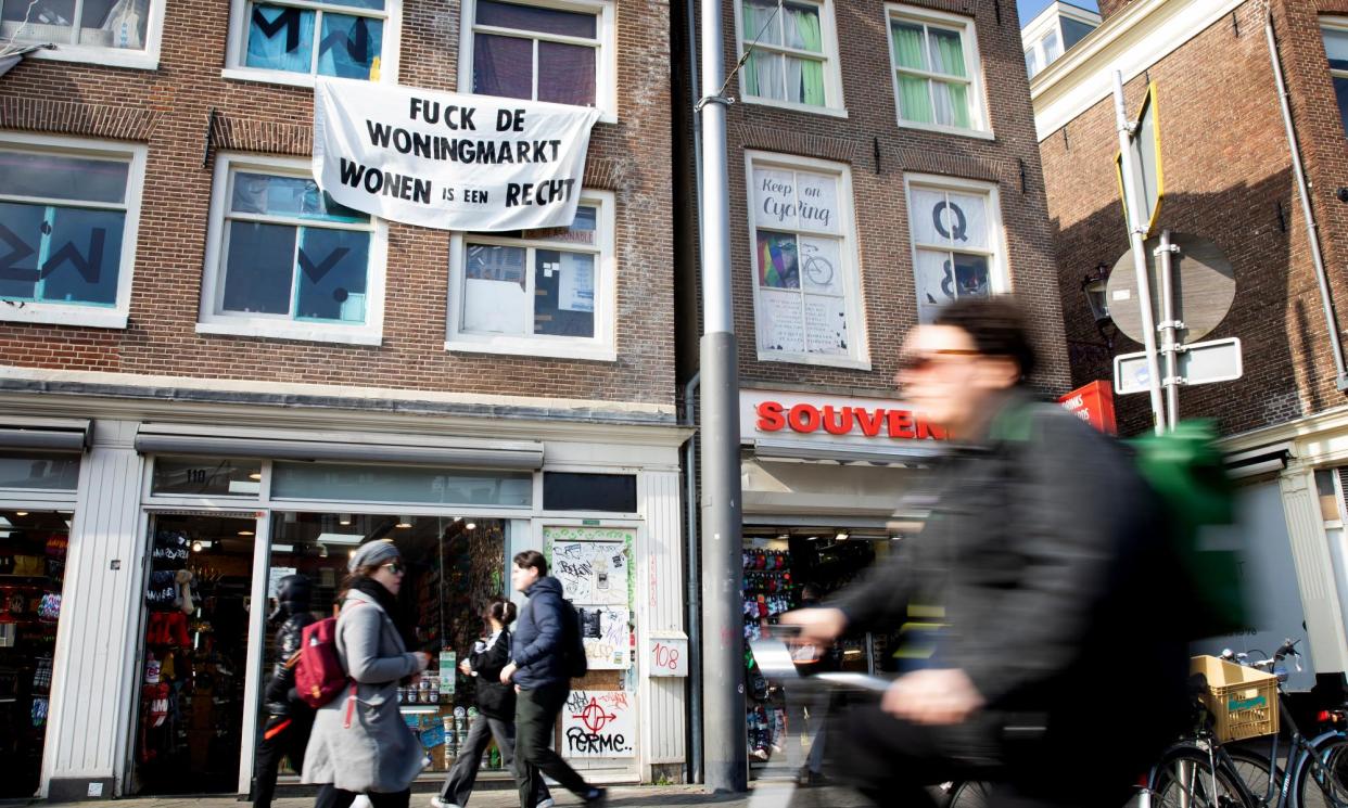 <span>A banner in Amsterdam bearing the message ‘fuck the housing market’.</span><span>Photograph: Judith Jockel/The Guardian</span>