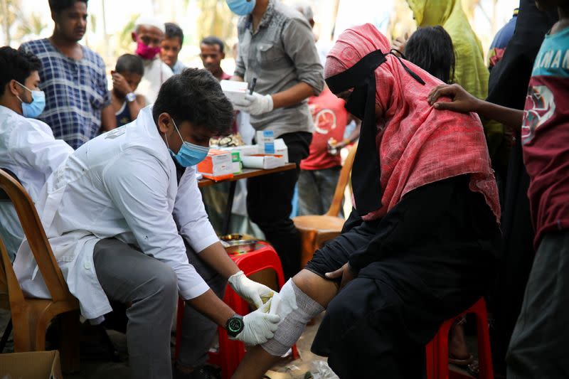 The Wider Image: 'Can't take this pain': Rohingya mother searches for son after refugee camp blaze