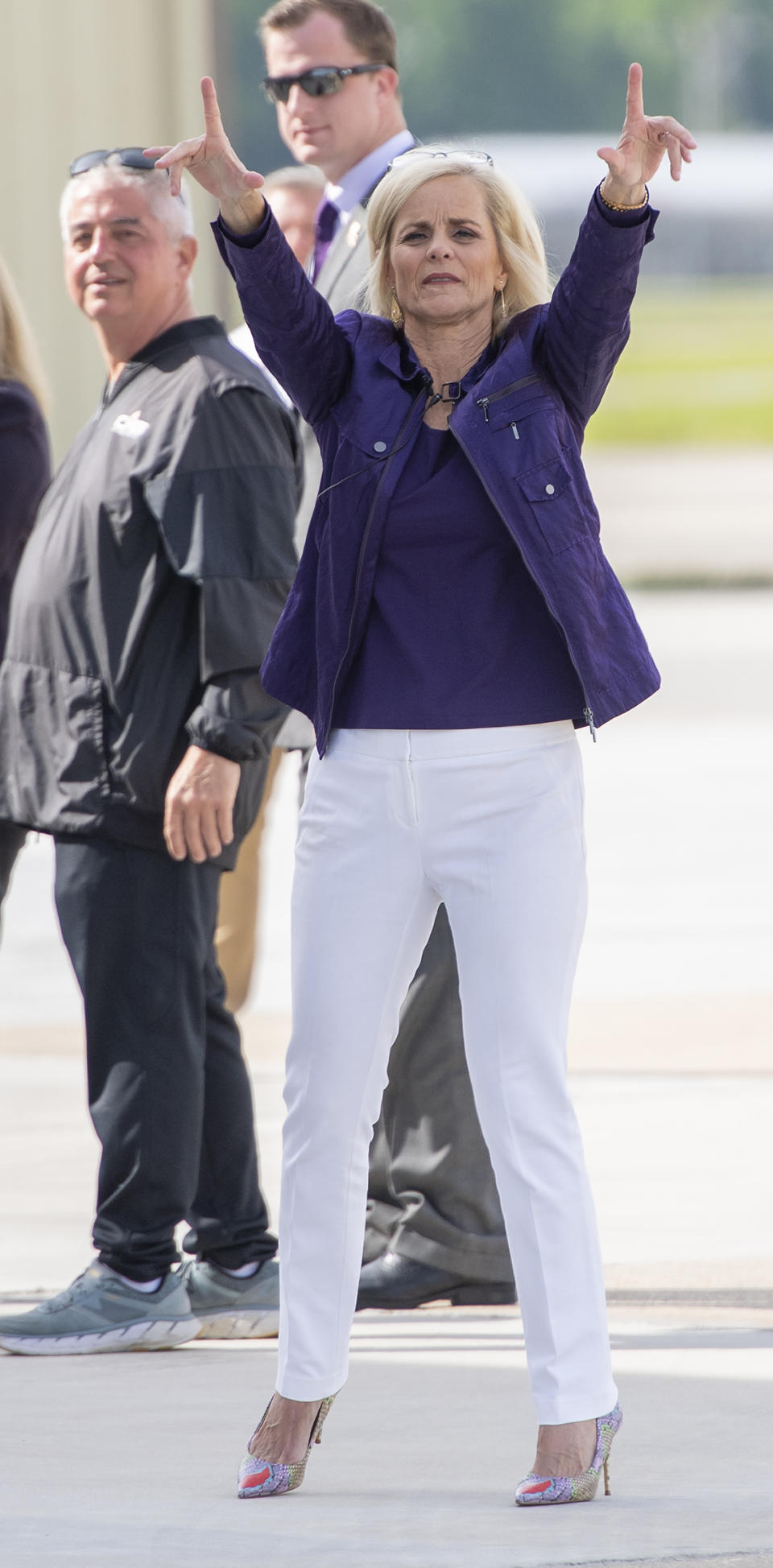 Former Baylor women's basketball coach Kim Mulkey waves the folks behind the fence after arriving at Metro Airport to become LSU's women's basketball coach Monday, April 26, 2021, in Baton Rouge, La. (Bill Feig/The Advocate via AP)