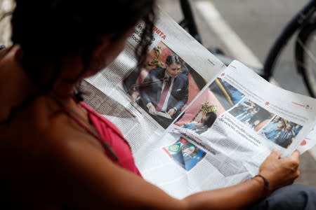 A woman reads a newspaper with news of Government crisis and the resignation of the Prime Minister Giuseppe Conte.