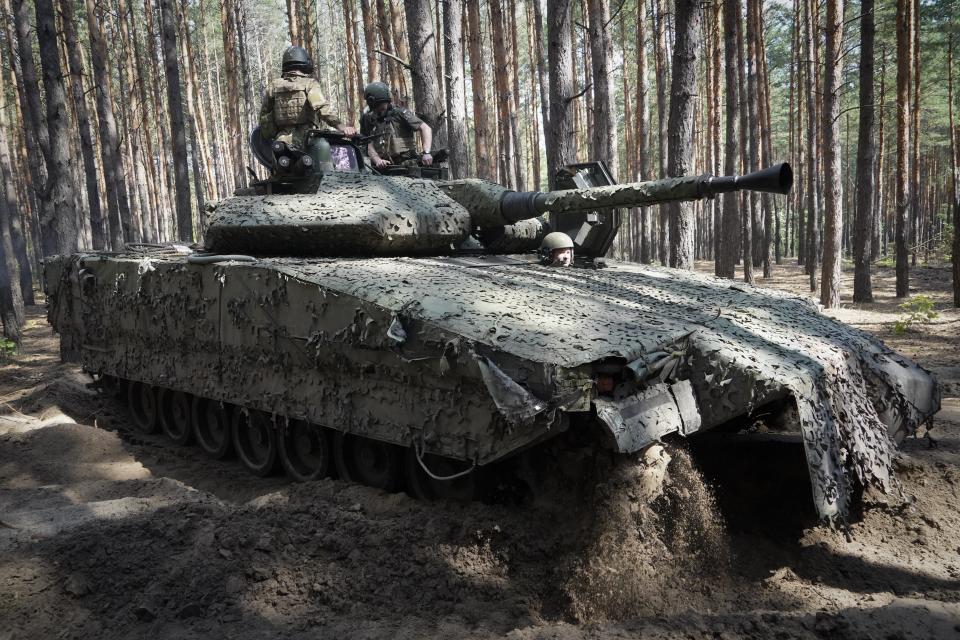 FILE - Ukrainian soldiers ride in a combat vehicle near the front line in the Kharkiv region of Ukraine, on Tuesday, June 18, 2024. Russia's offensive near the city of Kharkiv that began in May has apparently lost momentum after Ukraine bolstered its forces in the area by redeploying troops there from other sectors. (AP Photo/Andrii Marienko, File)