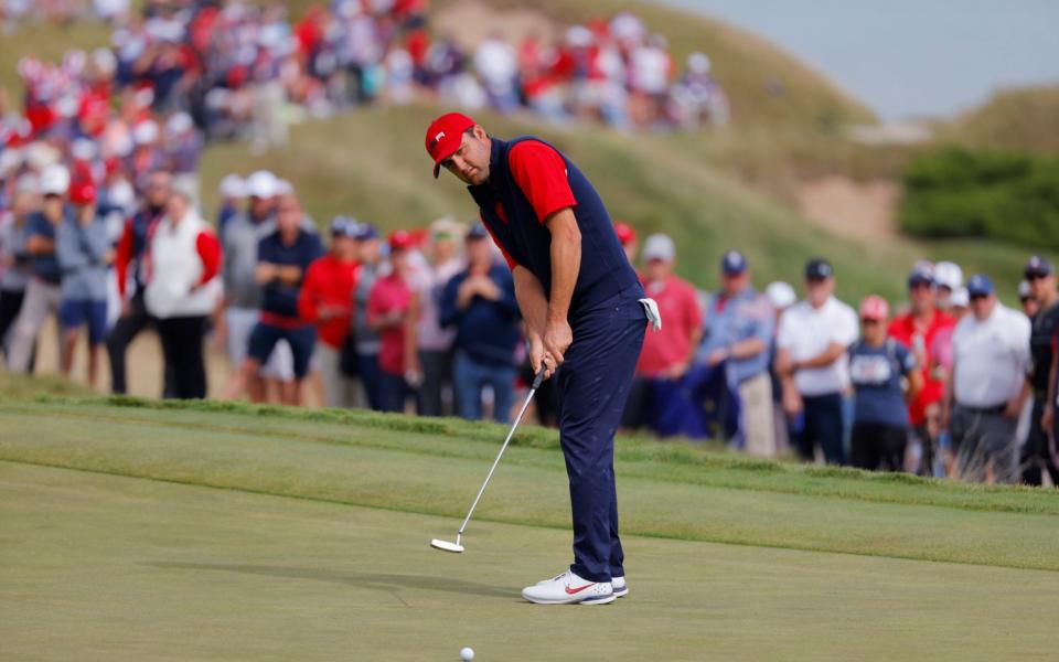 Team USA's Scottie Scheffler hits his putt on the 2nd green during the Singles.  - REUTERS/Mike Segar