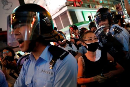 Riot police try to disperse anti-extradition bill protesters after a march at Hong Kong's tourism district Mongkok