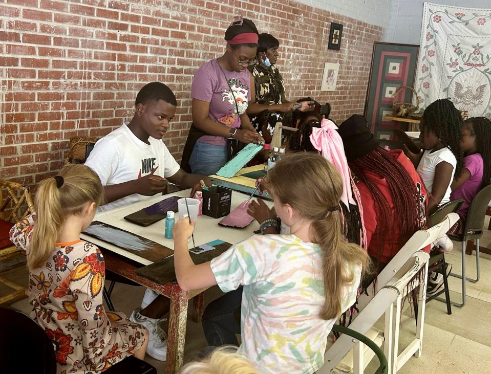 Young people work on art projects during a Juneteenth event in Camden.