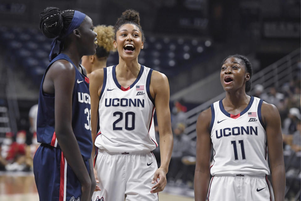 Connecticut's Piath Gabriel, left, Olivia Nelson-Ododa and Mir McLean, right, laugh during First Night events for the UConn men's and women's NCAA college basketball teams Friday, Oct. 15, 2021, in Storrs, Conn. (AP Photo/Jessica Hill)