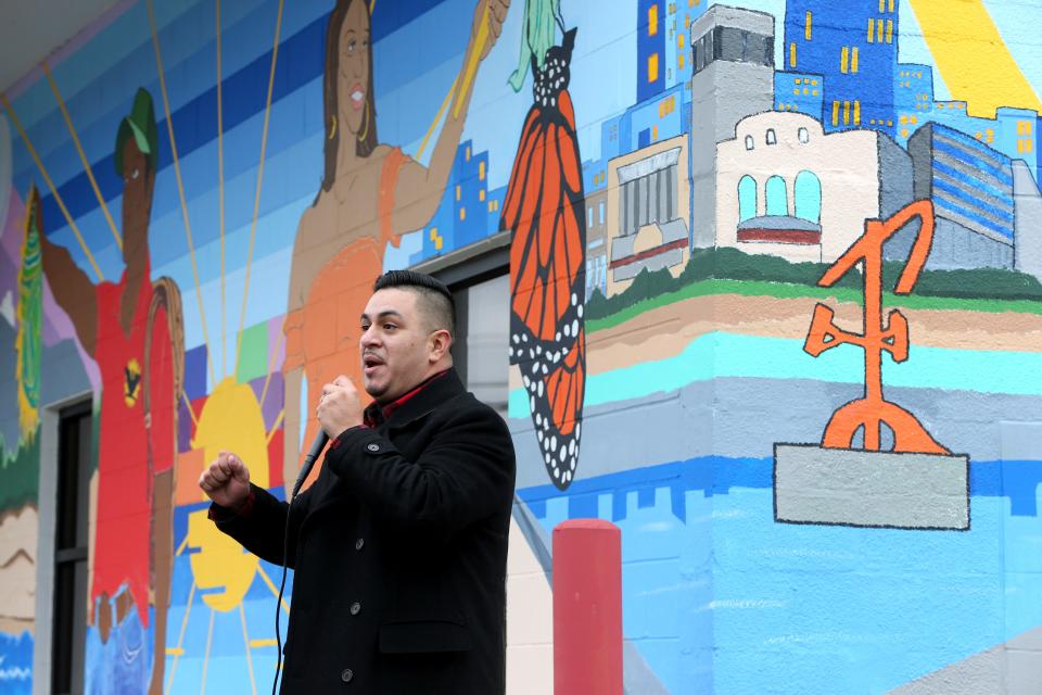 Artist Freddy Rodriguez stands before the formal dedication Dec. 12, 2022, of his mural on the La Casa de Amistad building at 3423 S. Michigan St. in South Bend.