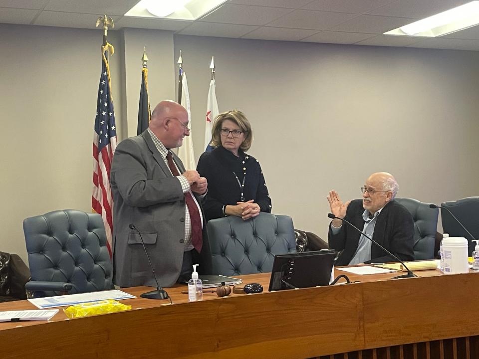 The three members of the St. Joseph County Election Board, Tom Dixon, left, Amy Rolfes, center, and Chuck Leone, right, debrief following Wednesday's meeting.