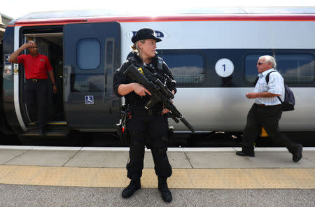 An armed police officer patrols on a platform at Milton Keynes station, Britain May 25, 2017. REUTERS/Neil Hall