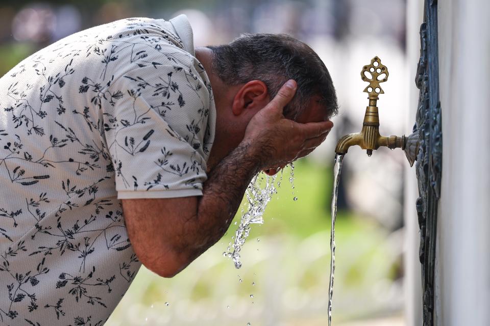 A man cools off at a fountain in Istanbul, Turkey (EPA)