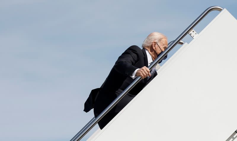 U.S. President Joe Biden stumbles on steps departs on travel to Atlanta, Georgia at Joint Base Andrews in Maryland