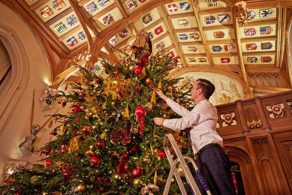 For single use only in relation to the Christmas displays at Windsor Castle in 2020, not to be archived, sold on or used out of context. Undated handout photo issued by the Royal Collection Trust of Royal Collection Trust staff put the finishing touches on the 20-foot-high Christmas tree in St George's Hall, the largest room in Windsor Castle, which can be enjoyed by visitors to the Castle from Thursday.