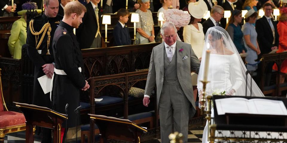 <p>Walking Meghan Markle down the aisle at St. George's Chapel during her wedding to his son, Prince Harry. </p>