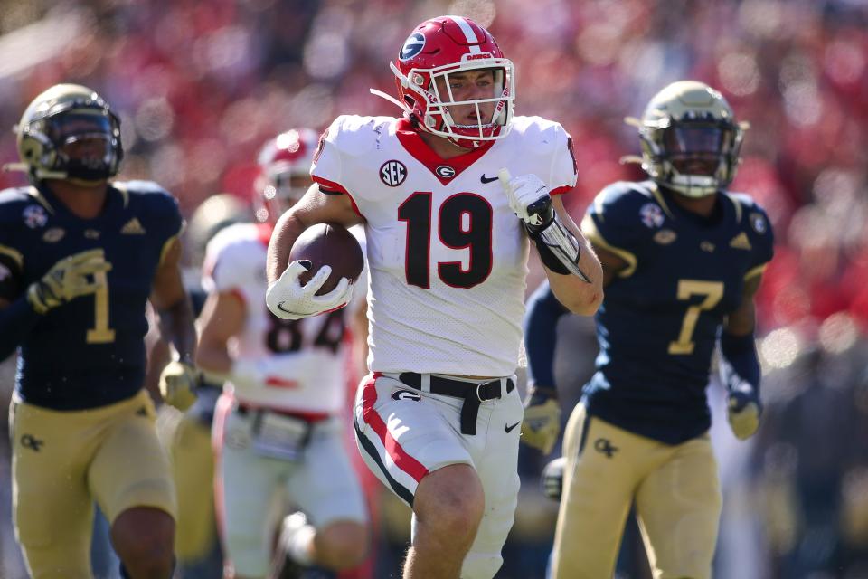 Nov 27, 2021; Atlanta, Georgia, USA; Georgia Bulldogs tight end Brock Bowers (19) scores a touchdown against the Georgia Tech Yellow Jackets in the second quarter at Bobby Dodd Stadium. Mandatory Credit: Brett Davis-USA TODAY Sports