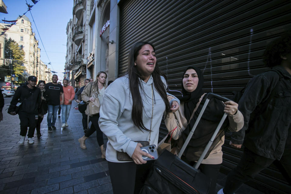 FILE - People leave the area after an explosion on Istanbul's popular pedestrian Istiklal Avenue Sunday, Istanbul, Sunday, Nov. 13, 2022. A bomb exploded on a major pedestrian avenue in the heart of Istanbul on Sunday, killing a handful of people, wounding dozens and sending people fleeing as flames rose. (AP Photo/Can Ozer, File)