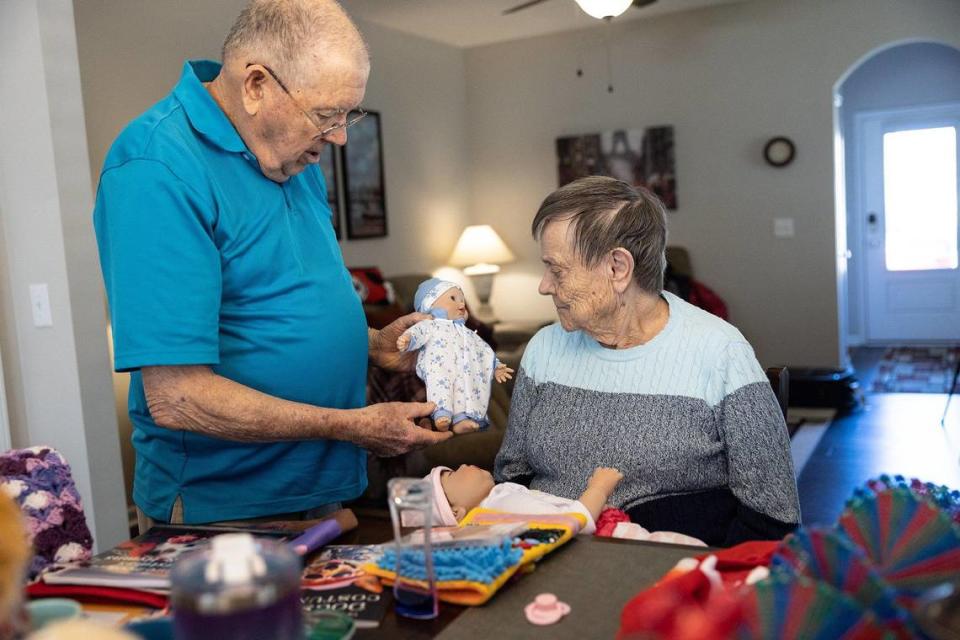 Bob Pettit, left, shows his wife, Betty, a doll that a fan sent to her in Mooresville, N.C., on Friday, November 18, 2022.