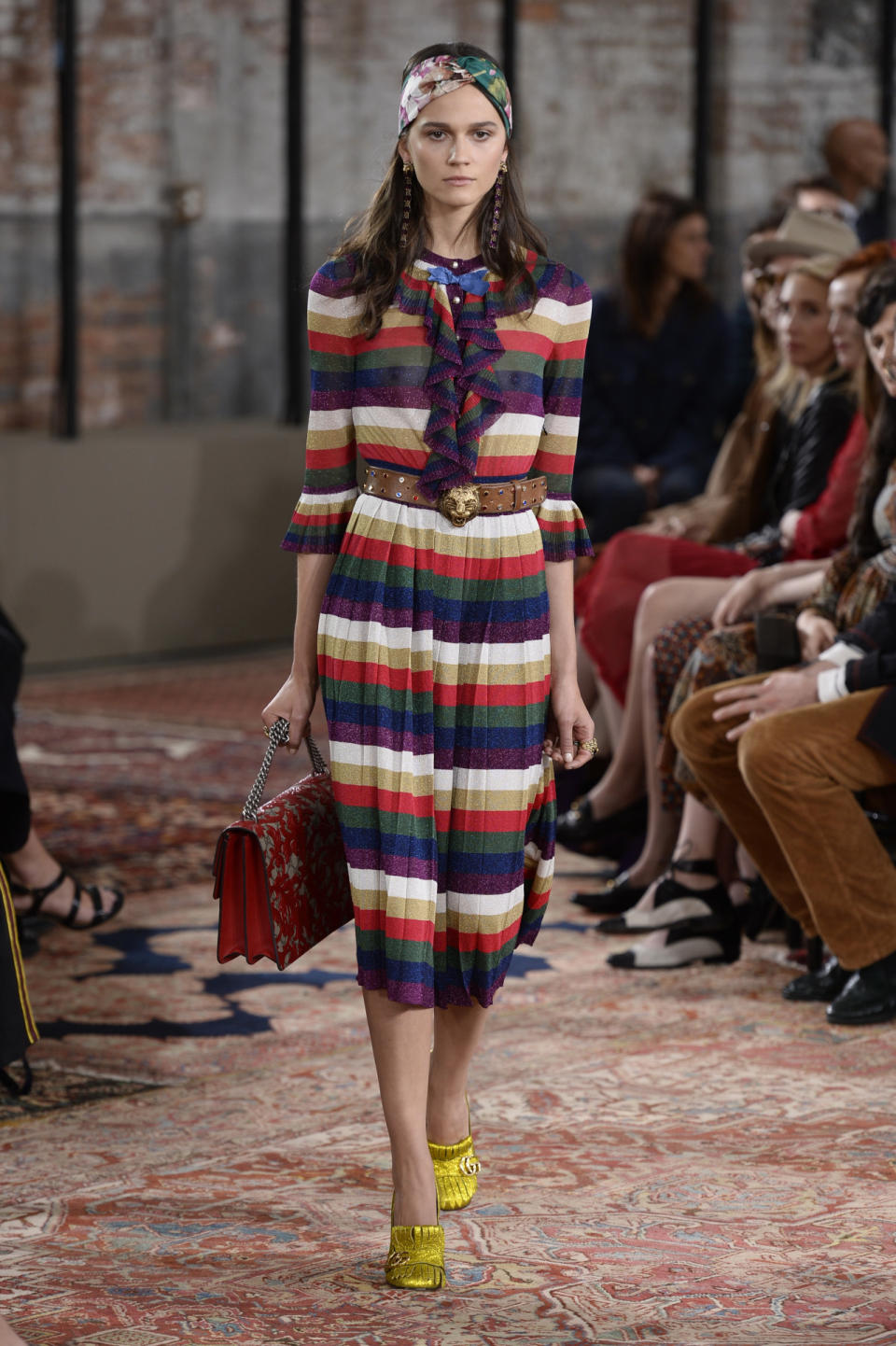 A striped dress worn with sparkling yellow mules at the Gucci Resort show.