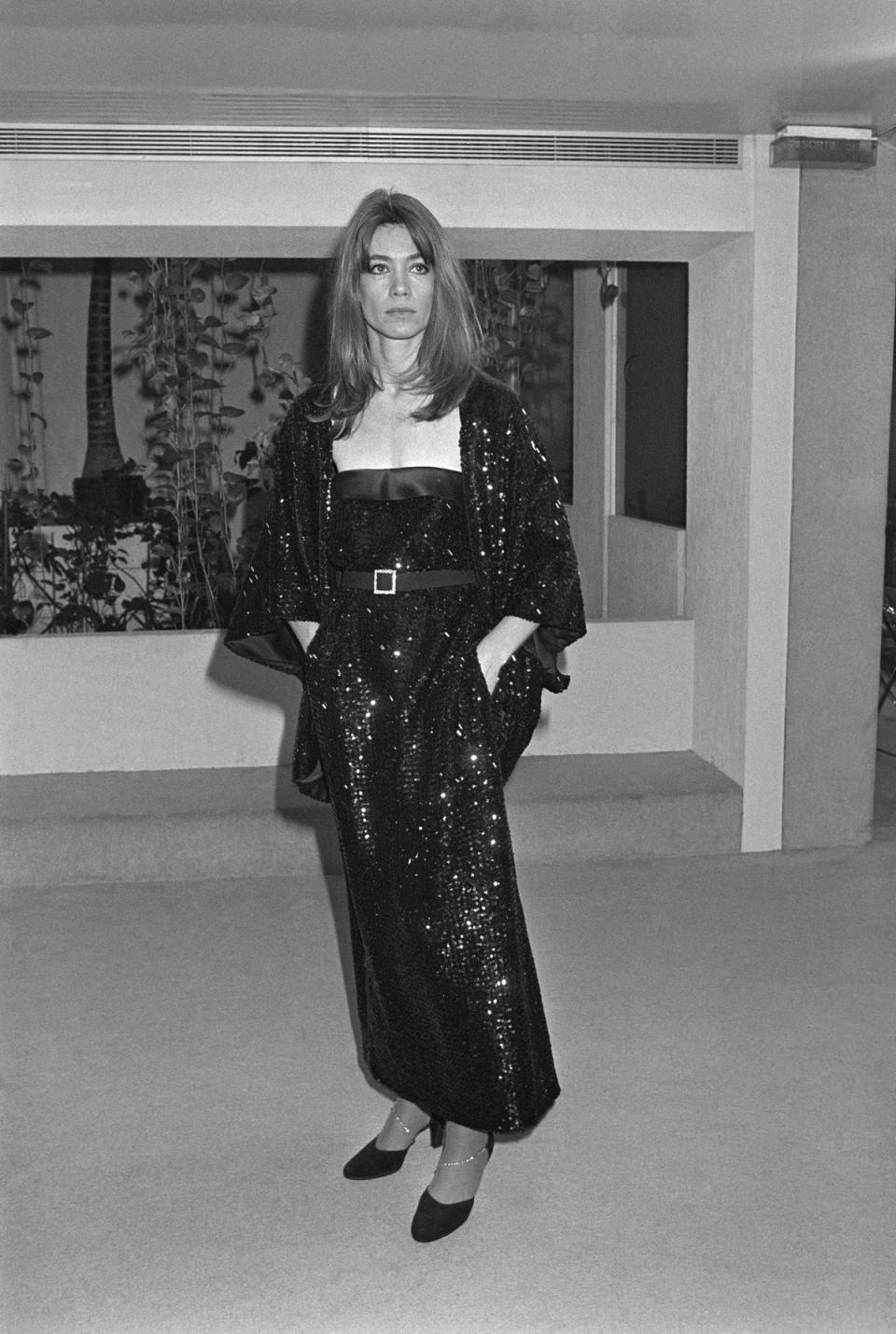 Wearing a sequined sheath dress worn with a matching poncho, presents the Spring-Summer 1979 haute-couture collection of the Torrente house, on November 24, 1978 in Paris. (AFP via Getty Images)