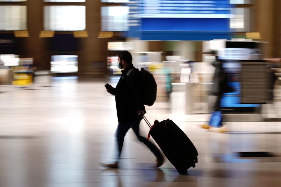 A man walks through the 30th Street Station ahead of the Thanksgiving holiday, Friday, Nov. 20, 2020, in Philadelphia. With the coronavirus surging out of control, the nation's top public health agency pleaded with Americans not to travel for Thanksgiving and not to spend the holiday with people from outside their household. (AP Photo/Matt Slocum)